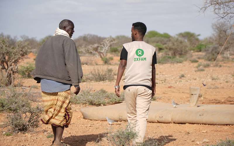 Two men standing in front of vast landscape in Somalia