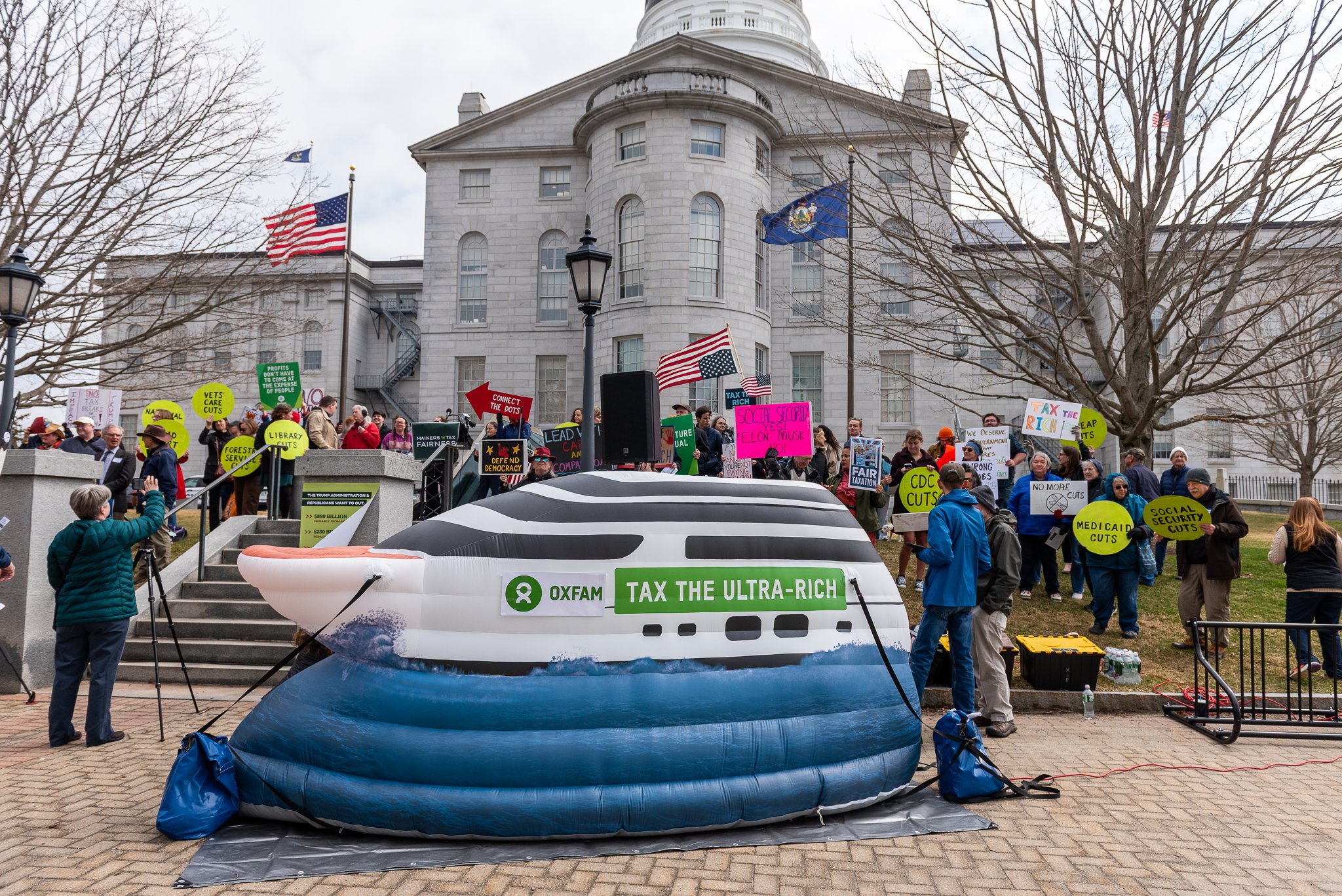  Oxfam staff and allies at a tax rally in Augusta, Maine on April 15, 2025. 