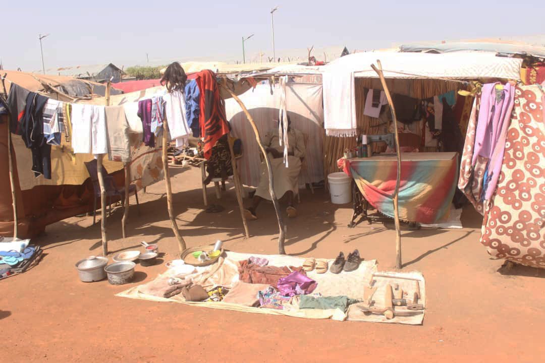  Items for sale are displayed in front of a makeshift shelter at the transit center in Renk, South Sudan. 