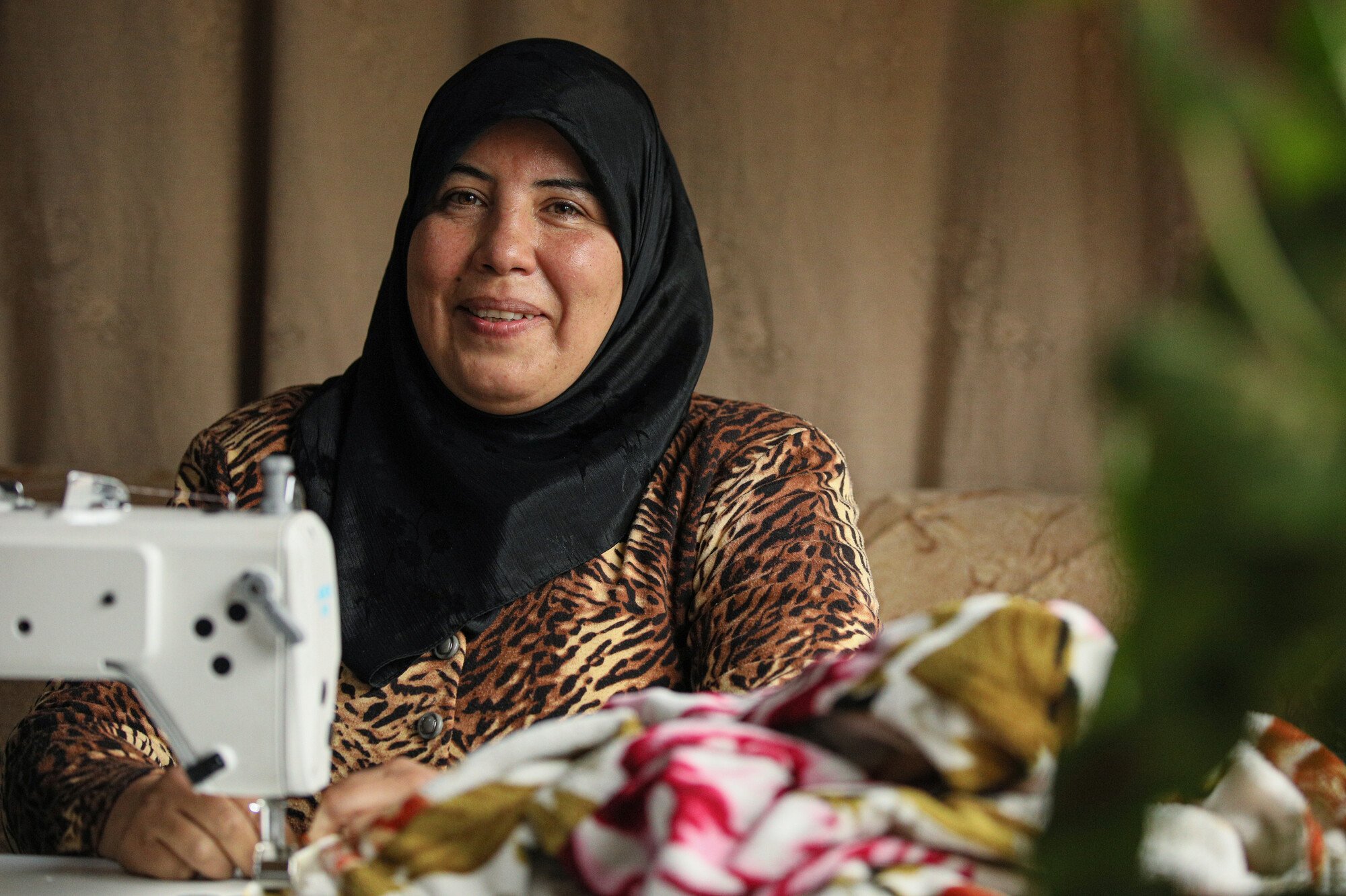  Amal, 48, a mother from Aleppo, got a sewing machine from Oxfam and participated in a training program. “I'm now ready to start my small business and support my family.” 