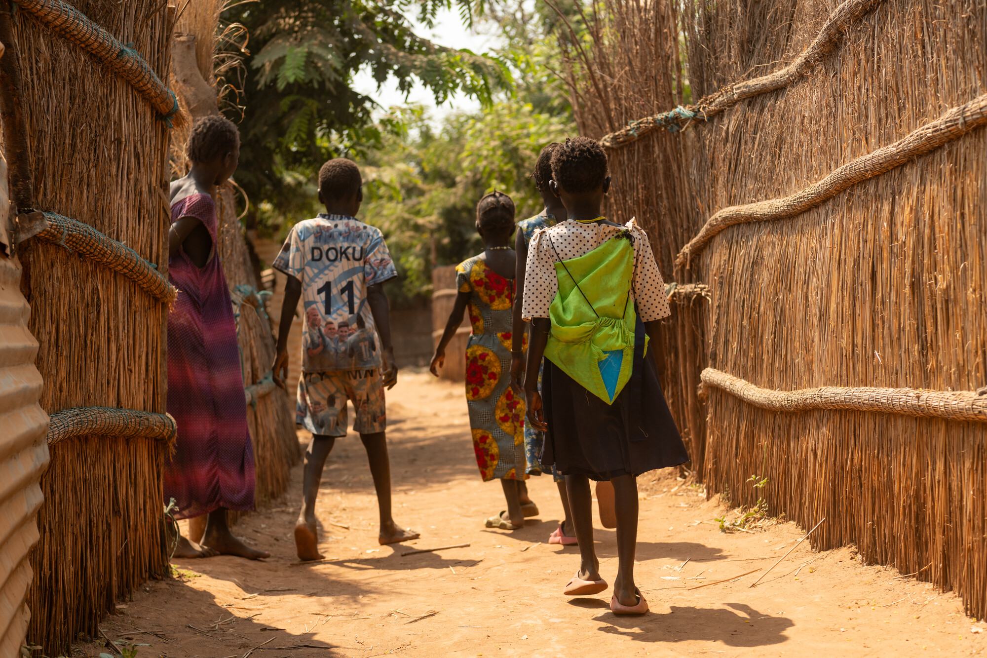  Students walk home from school through a camp for South Sudanese refugees in western Ethiopia. Cuts to aid programs that fund immunization for children will increase the risk of preventable deaths in the coming years. 