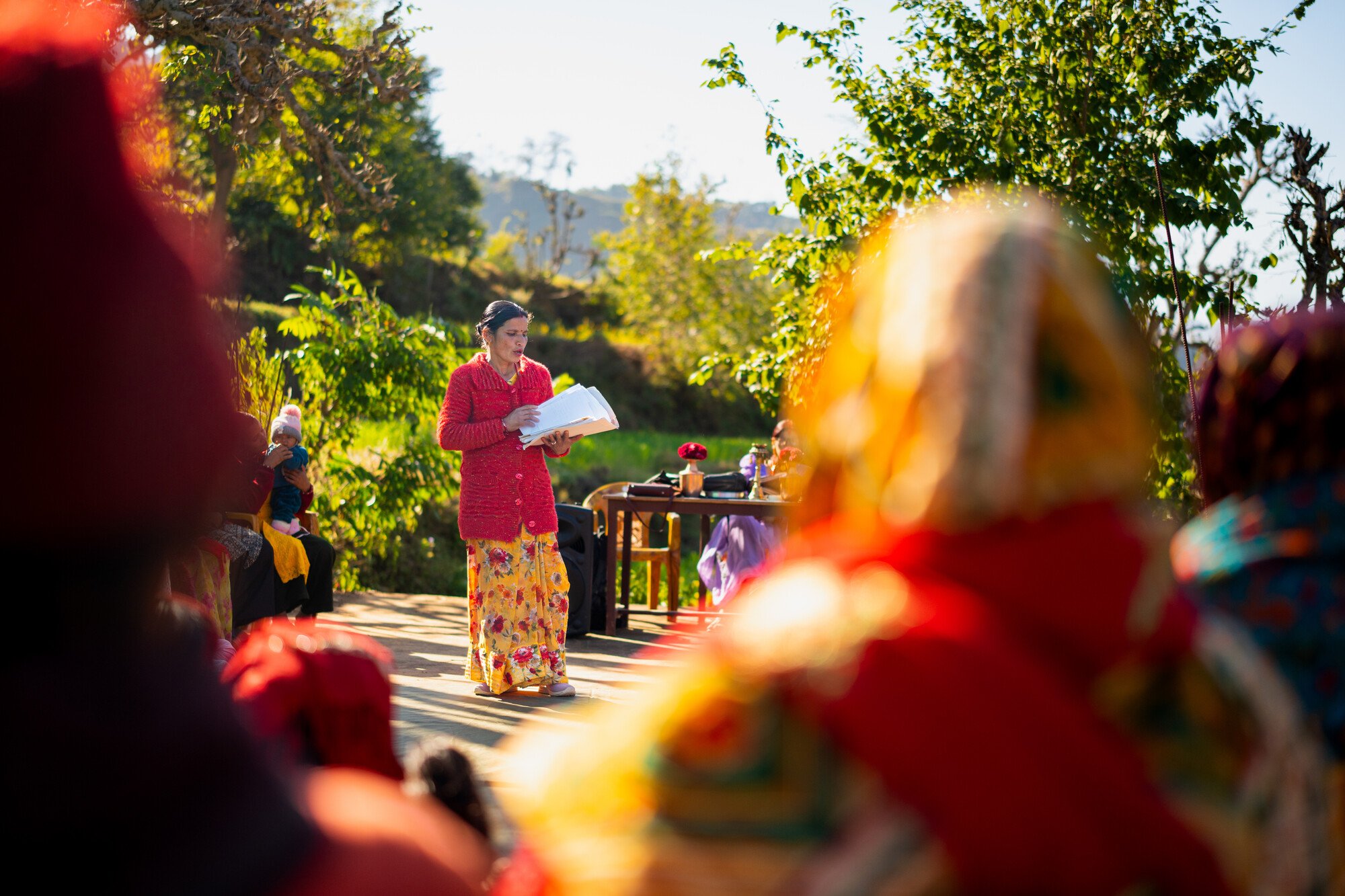  Pramila Buhl speaks at a meeting of a women’s cooperative group in her village. 