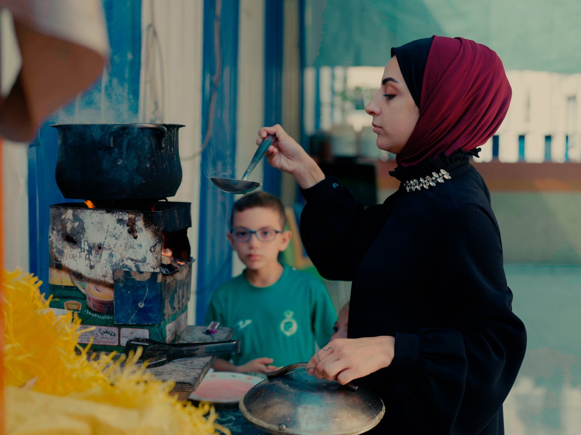 Hiba, 27, prepares a meal over a wood fire for her four children. She lost her first husband during conflict with Israel in Gaza in 2021, and her second husband died during the current war when it started in late 2023. The Culture and Free Thought Associa