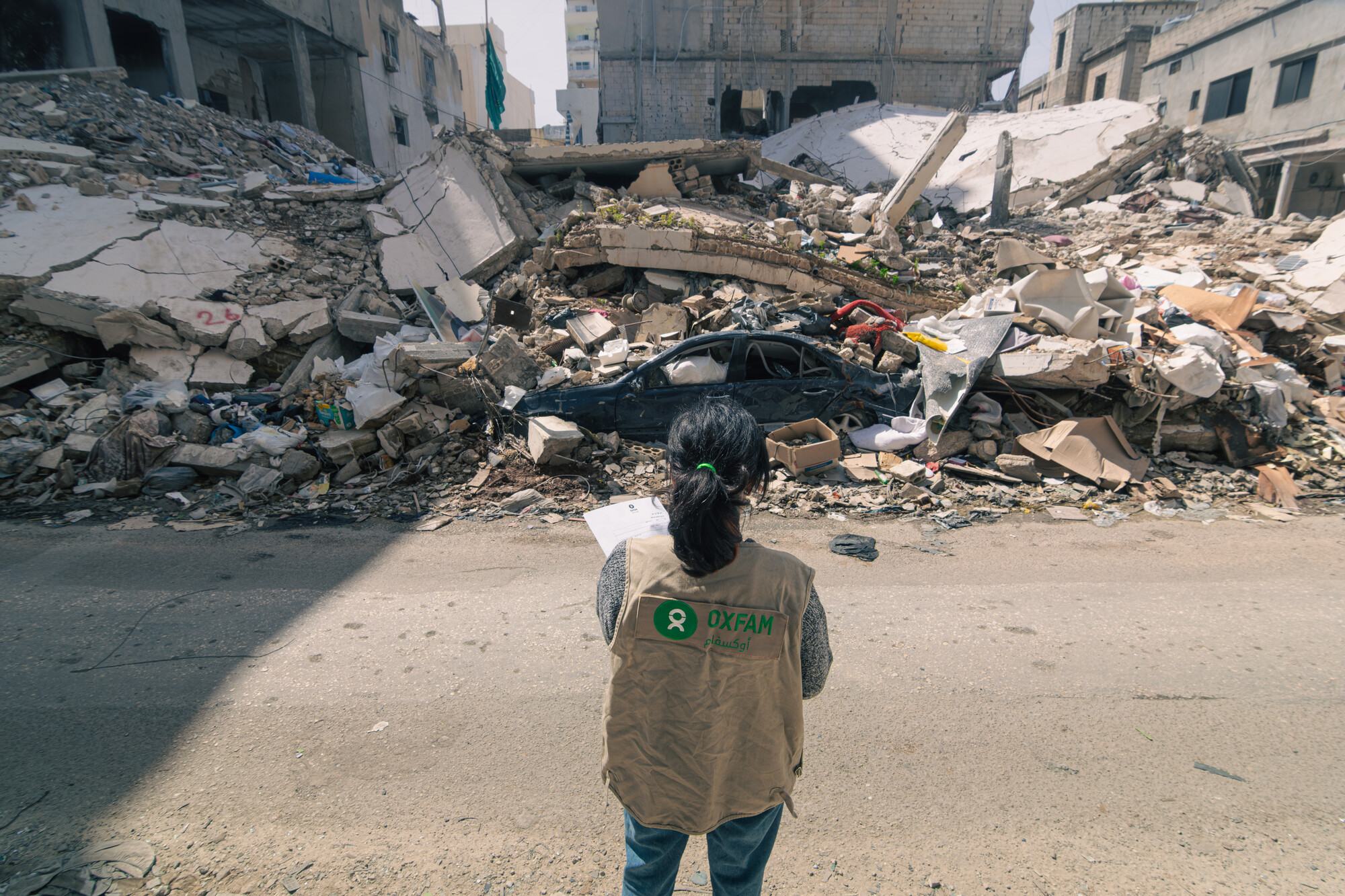  Oxfam staff look over areas of Tyre destroyed in Israeli airstrikes. 