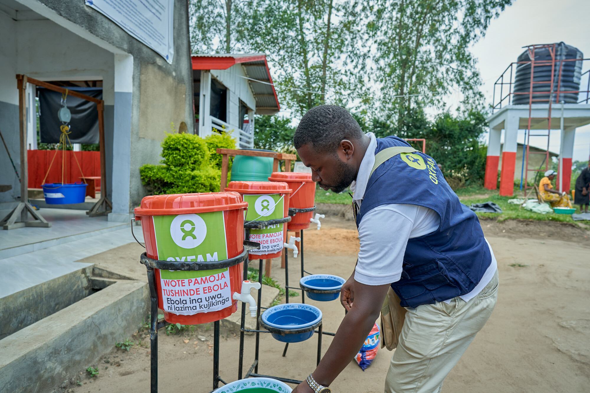  Oxfam staff installs handwashing stations at a health center in Shari, Ituri province in eastern Democratic Republic of Congo. 