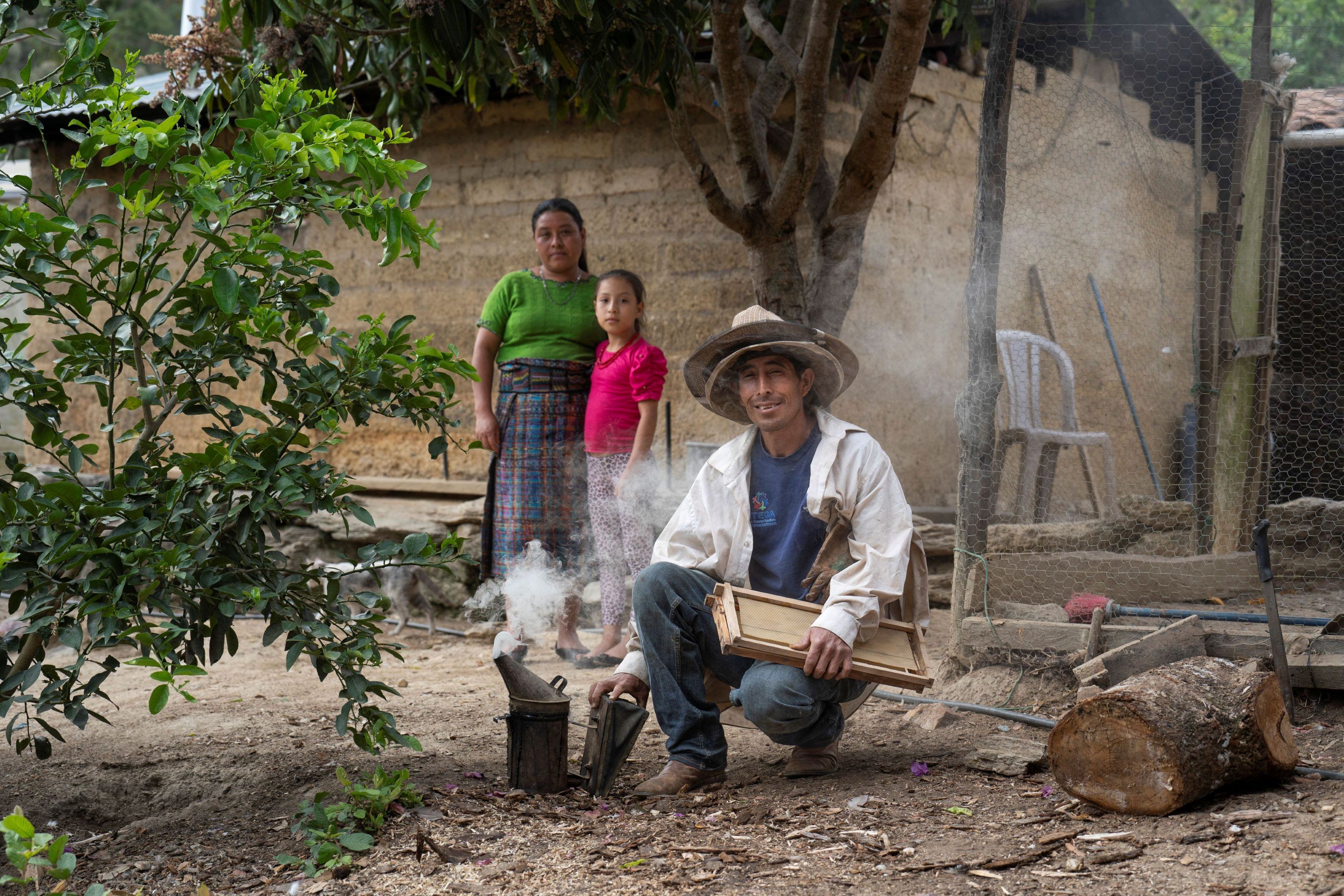  Don Mario René Gonzalez Córdova, his wife Vilma, and their daughter Angeli proudly show their family’s honey production in Xesiguan, Baja Verapaz, Guatemala. 