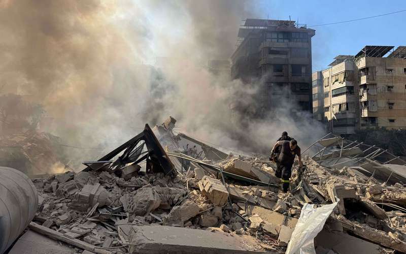 Rescue worker walking through rubble in Lebanon