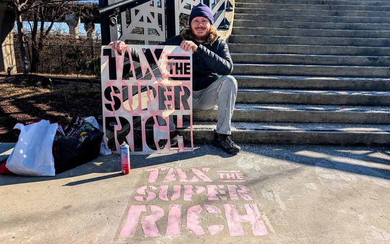 Oxfam staff try out our new Tax the Super-Rich stencil in their communities